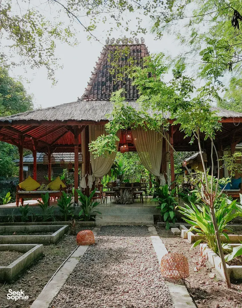 Garden courtyard seating with draped curtains at The Kitchen Garden Bajo for Traditional Manggarai vegan cooking, Labuan Bajo