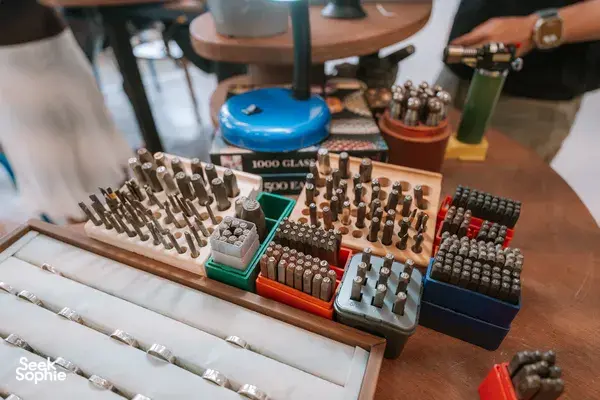 Tray of metal ring inserts and stamp tools on a worktable at Fat Anvil Studios in Singapore, workshops in Singapore