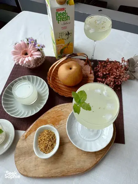 TCM-inspired mocktail tasting table with citrus drink glasses, pear, herbs and bowls of spices during craft workshops in Singapore