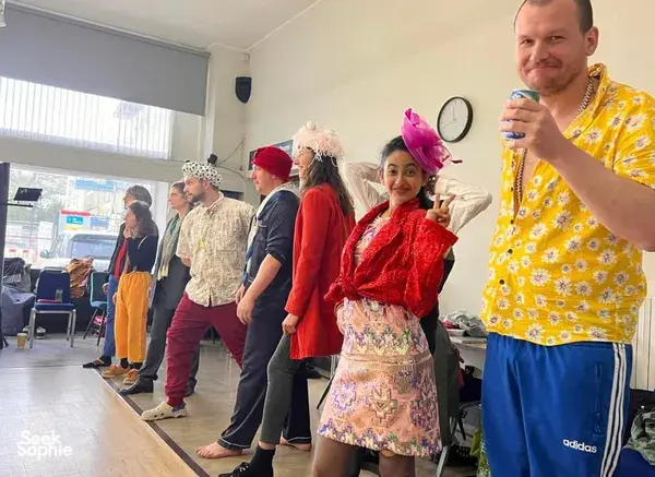 Costumed teammates play improvisation games in a Singapore clowning workshop, learning to make mistakes for team building Singapore