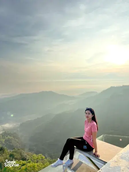 Sunrise over misty volcano ridges from a stone lookout platform in Yogyakarta on the Picnic Indonesia-led coffee farm experience