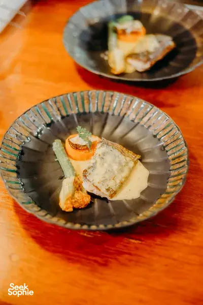 Ceramic plates with a plated appetiser at The Farmer’s Lab, a home cooking class in Chiang Mai with local sustainable ingredients