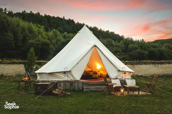 White canvas tent lit by lanterns during a 2D2N Tibetan mountain valley stay with Caravan Treks by Ferme Liotard in Shangri-La