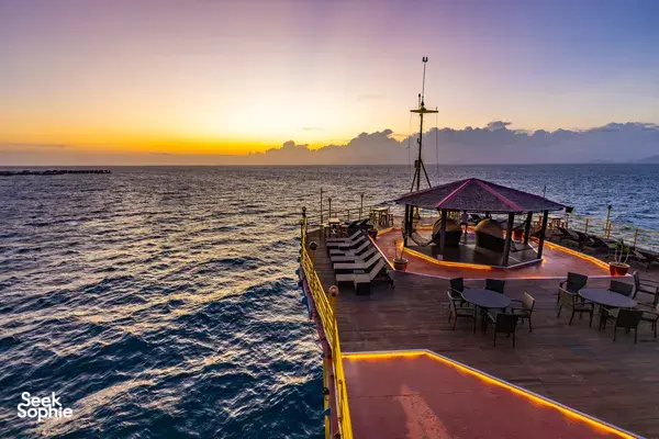 Wooden deck on the Seaventures Dive Rig at sunrise near Semporna, with chairs overlooking the South China Sea