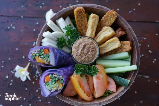 Healthy breakfast bowl with vegetables, sliced crackers and dip served at the wellness retreat in Bali, Canggu