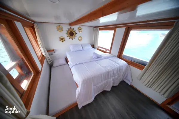 Two twin beds inside an onboard cabin on a join-in 3D2N Komodo trip, with sea views near Komodo Island