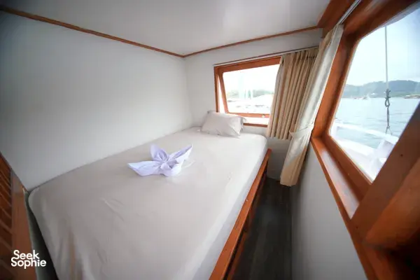 Travass Life 3D2N join-in Komodo trip cabin bed with folded towel swan and window sea views, Labuan Bajo