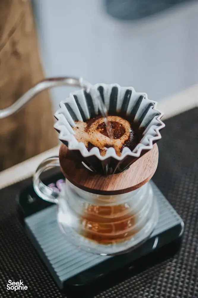 Brewed pour-over coffee dripping into a carafe during a Bali Beans coffee experience at their Kintamani farm, Bali