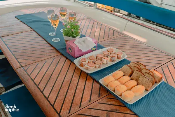 Breakfast spread on the deck of a catamaran sailing off Kota Kinabalu, with pastries, muffins and fresh drinks