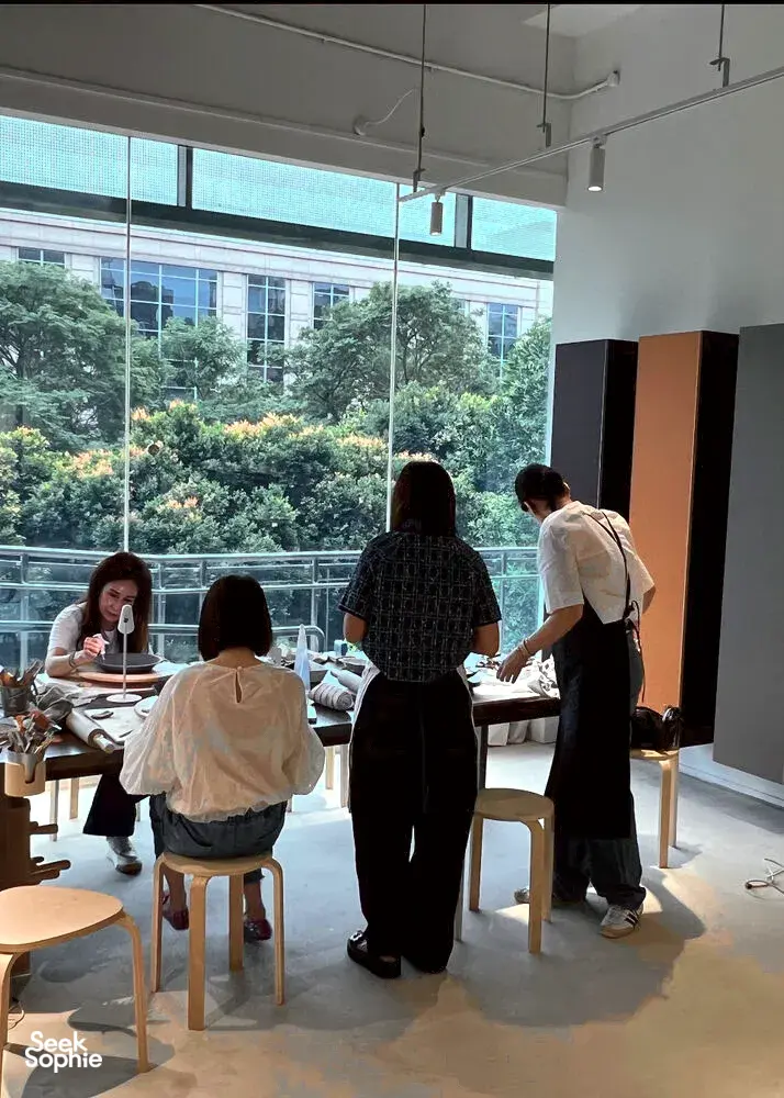 Pottery class in a bright Singapore studio as participants work at tables by large windows for workshops in Singapore