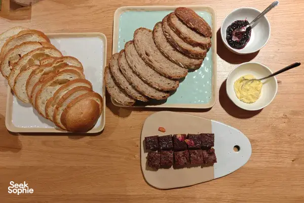 Tasting table with sliced shio-pan-style bread, butter and jam, plus brownies on wooden boards at The Daily Staples workshops in Singapore