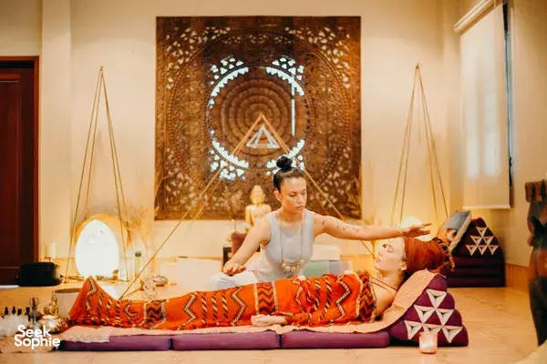 Therapist gently stretching a guest’s arms and hands during a relaxing massage session at Phuket Cleanse