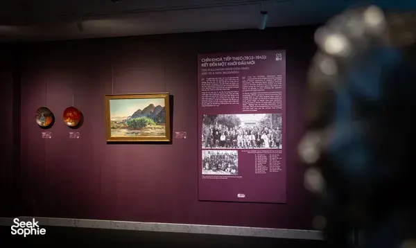 Framed Vietnamese artworks and wall information panels inside Quang San Art Museum in Ho Chi Minh City during an art tour