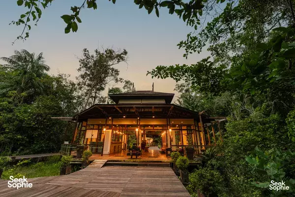 Kinabatangan Wetlands Resort eco-lodge with an elevated wooden deck and lights in the jungle near Kinabatangan River