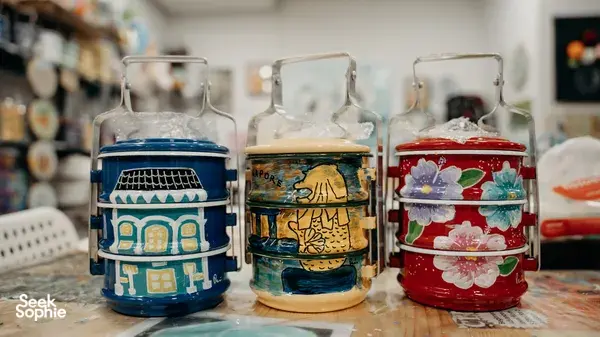 Painted Peranakan tingkat containers in the studio during workshops in Singapore on traditional techniques