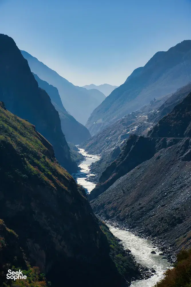 Mountain valley in China with a winding river running through steep cliffs, viewed from a high scenic lookout