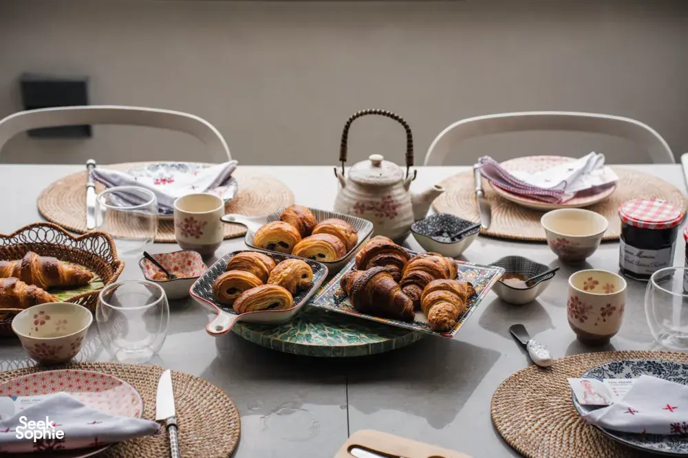 Croissants on serving trays with teapot and cups on a dining table in Singapore for a French Cooking Lab class, workshops in Singapore