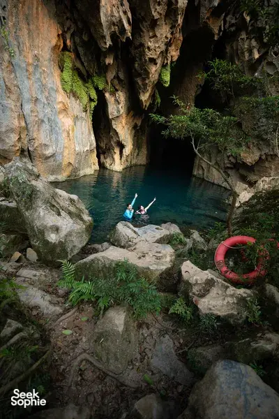 Kayakers paddle through a limestone cave river in Phong Nha on a 2D1N Moc Nam Adventure trek, paddle and explore tour