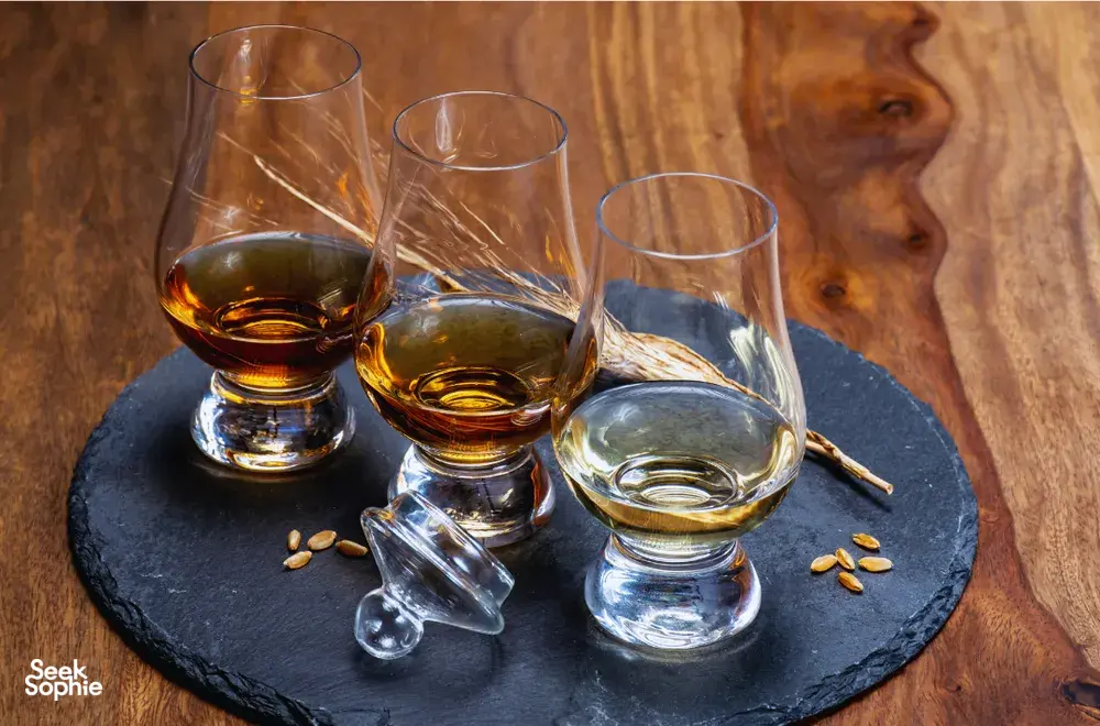 Amber whisky in clear tumblers on a slate coaster at a hidden home bar, private dining Singapore with Scotch & Sambal