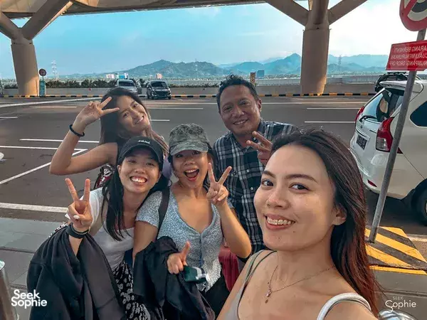 Travellers posing on an open-air road viewpoint during a 10-hr private car and driver hire in Yogyakarta