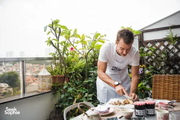 Chef preparing croissants on a rooftop garden terrace in Singapore with French Cooking Lab, workshops in Singapore