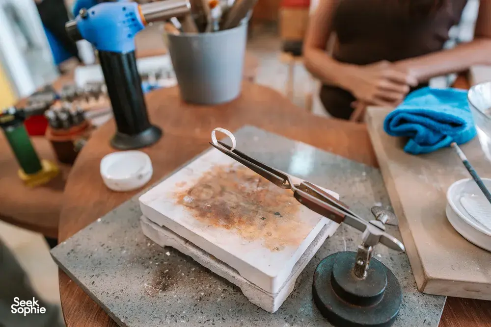 Silver ring-making tools and metal blanks on a bench at Fat Anvil Studios in Singapore, workshops in Singapore
