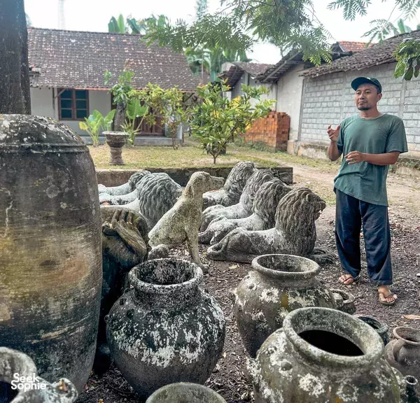 Sulis from Picnic Indonesia stands in a courtyard of handmade earthenware pots and urns in Yogyakarta pottery village