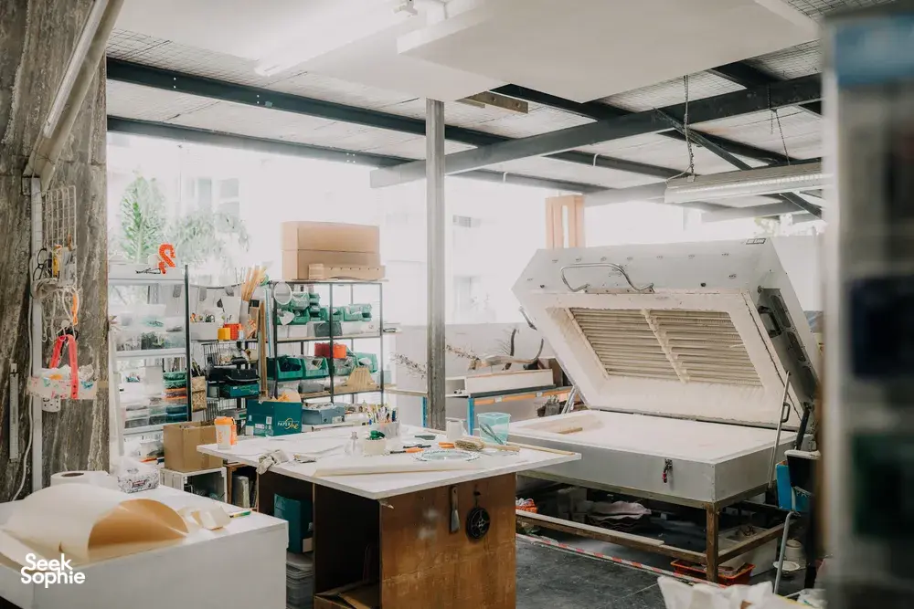 Glass studio in Singapore with a kiln and workbench for creating centrepieces, tools arranged—workshops in Singapore