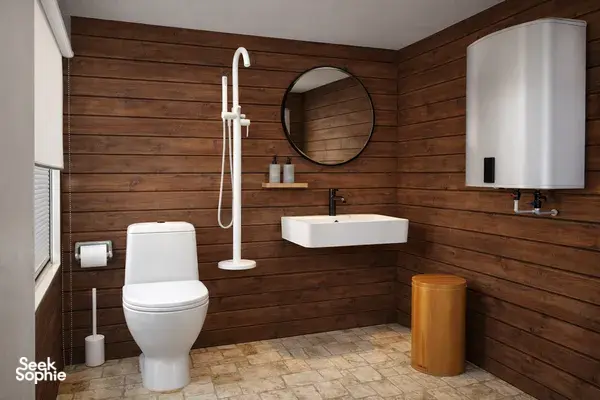 En-suite bathroom with toilet, sink and vanity mirror on a wooden phinisi during a 3D2N Komodo cruise in Labuan Bajo