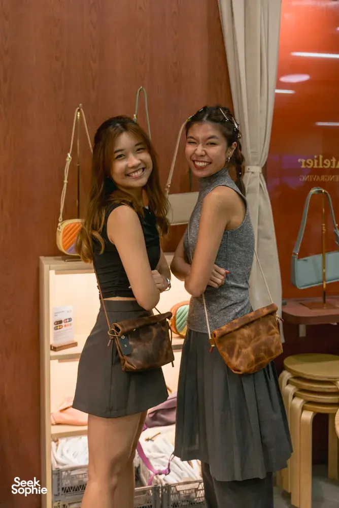 Participants smiling with handmade leather bags at Crafune leathercraft studio in Singapore—workshops in Singapore