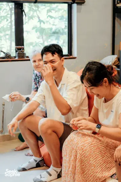 Participants in a clowning workshop practising playful improvisation games indoors, laughing together for team building Singapore