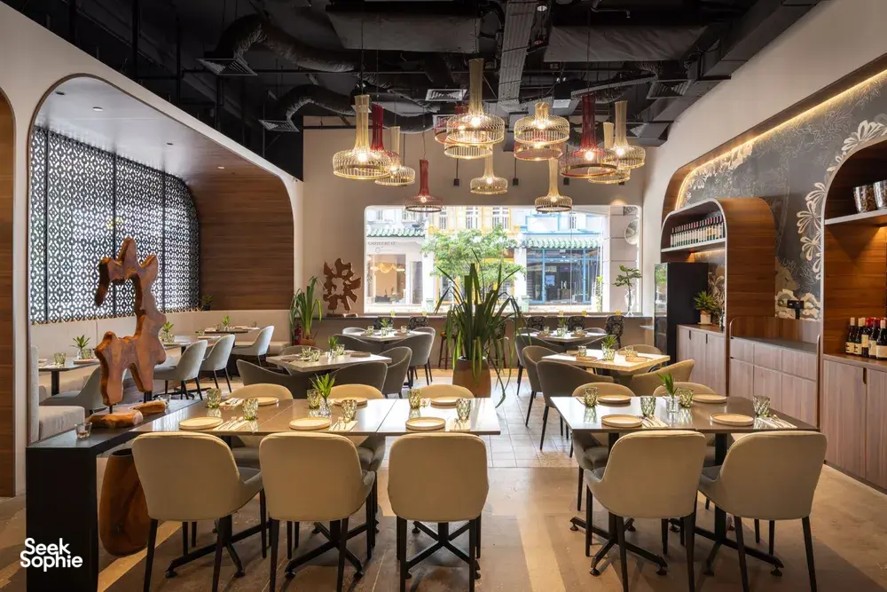 Set dining tables in Coriander Leaf’s Singapore venue for teams at local produce cooking challenge workshops in Singapore