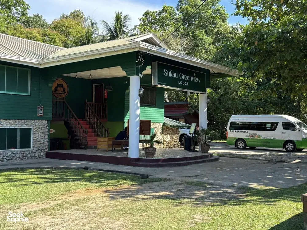 Sukau Greenview Lodge in Sandakan with porch and parked van in the driveway, part of a stay on the Kinabatangan River