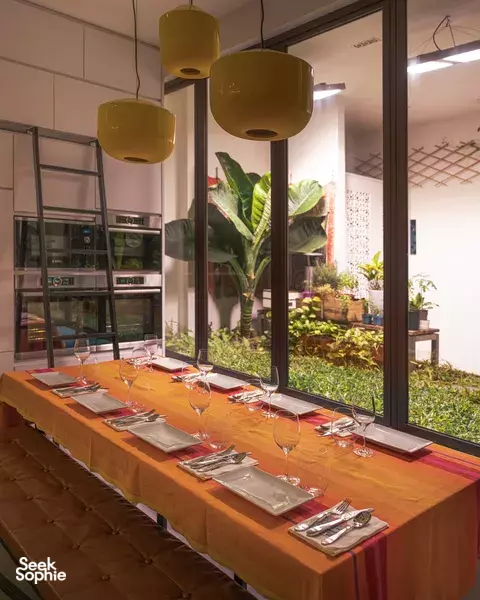 Calm dining table set with glassware in a Singapore shophouse courtyard alcove, ready for a Mediterranean 5-course private dining Singapore