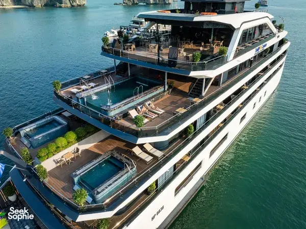 Top-down view of Doris Cruise decks with sunbeds and a small plunge pool on Halong Bay during a comfortable 2D1N cruise