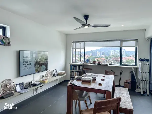 Singapore workshop room for TCM mocktails with a dining table, books, and large window overlooking the city skyline