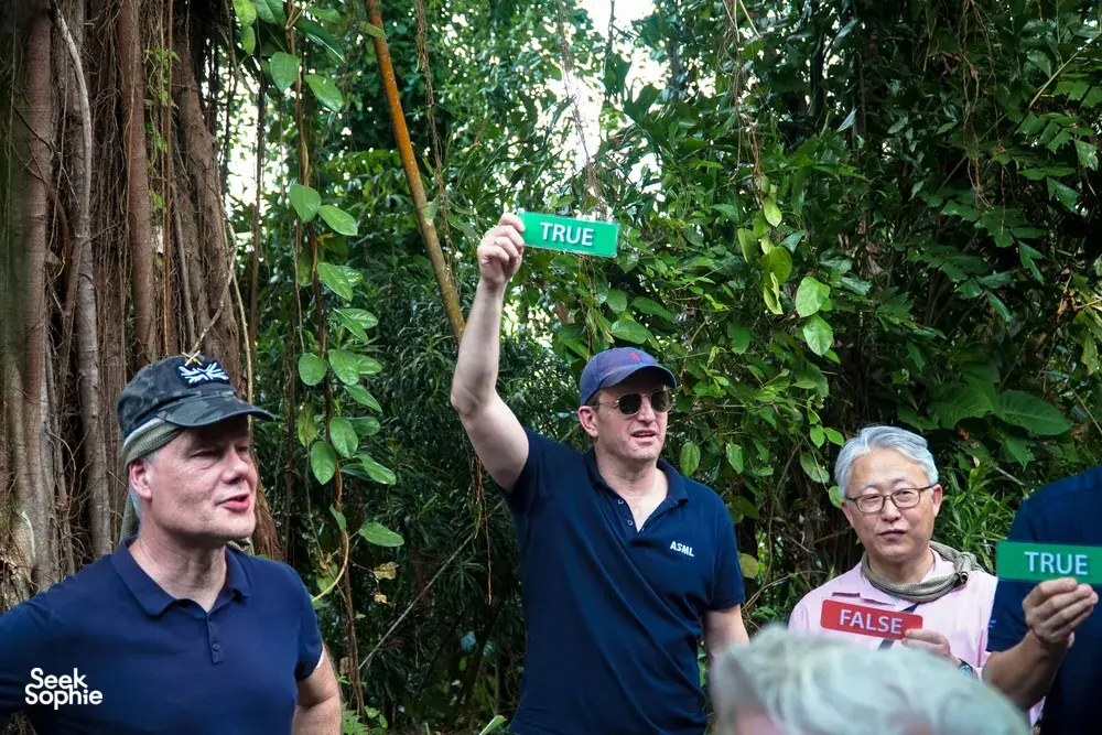 Group playing a TRUE-or-FALSE challenge in a Singapore forest during Fort Serapong discovery adventure