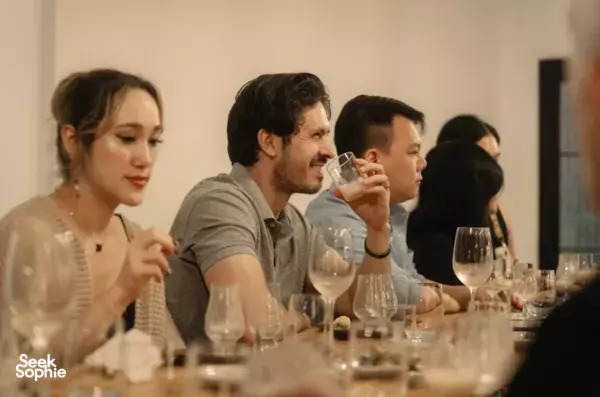 Cocktail making class in Ho Chi Minh City: guests taste and sip from stemmed glasses around a laid table