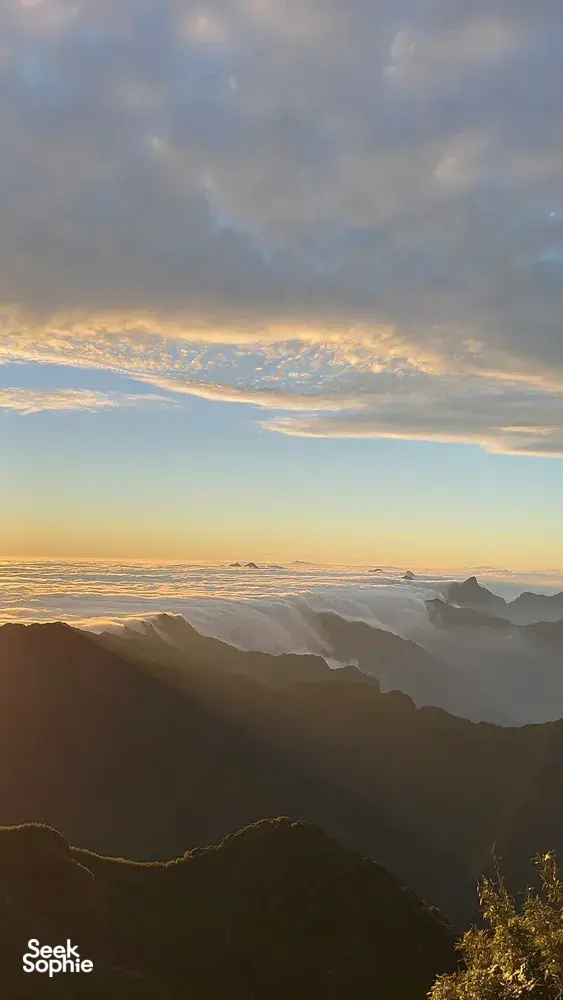 Golden-hour sunrise over layered cloud valleys from the Sapa mountains during a 1-day eco trek, at Mt Fansipan