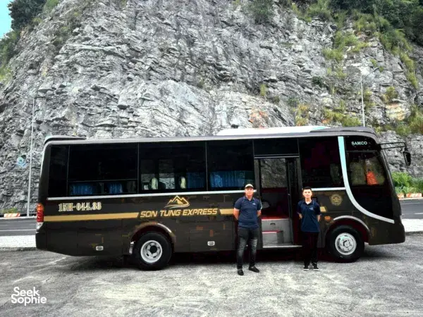 Son Tung Express coach bus stopped on a mountain road for Cat Ba to Halong transfer with ferry tickets included