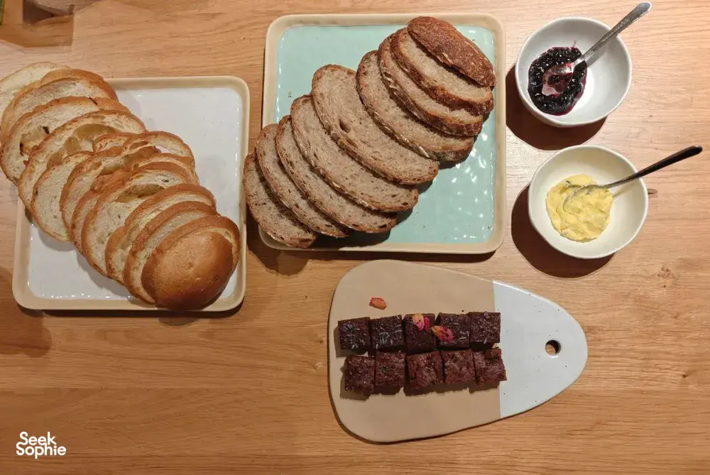 Tasting table with sliced shio-pan-style bread, butter and jam, plus brownies on wooden boards at The Daily Staples workshops in Singapore