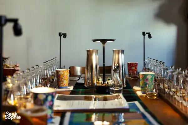 Small-batch whisky tasting table in a hidden Singapore home bar, with decanters and glassware ready for Scotch & Sambal