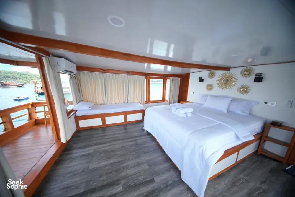 Double bed suite with sea-view windows on a boat for a 3D2N join-in Komodo trip from Labuan Bajo to Komodo Island