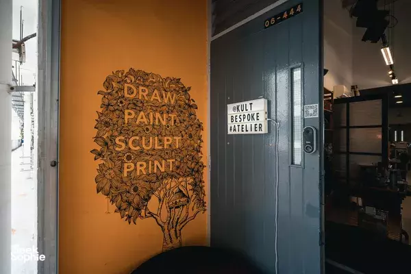 Exterior sign for Kult Bespoke atelier in Singapore featuring “DRAW PAINT SCULPT PRINT” on the wall, workshops in Singapore