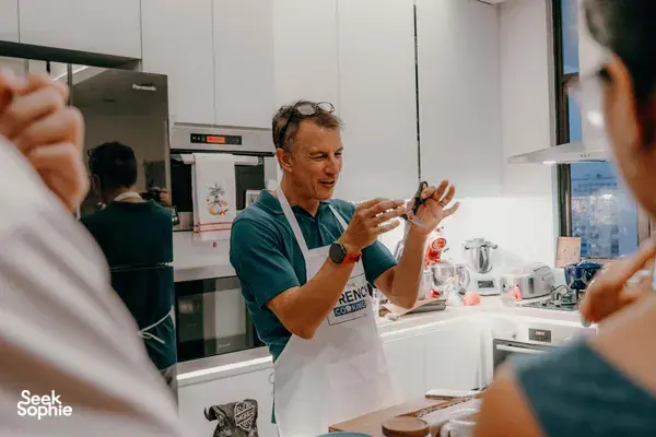 Eric from French Cooking Lab demonstrating baguette shaping at a cosy French cooking session in Singapore for private dining Singapore