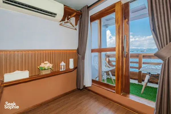 Bright boat-cabin room with open wooden door and sea-view balcony outside, La Famille 3D2N Join-In Komodo trip in Labuan Bajo