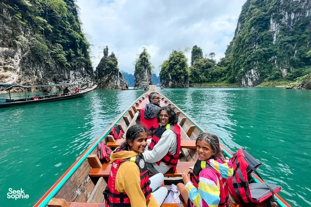 A group on a boat along limestone cliffs on Cheow Lan Lake during the 3D2N stay with Khao Sok Riverside Cottages