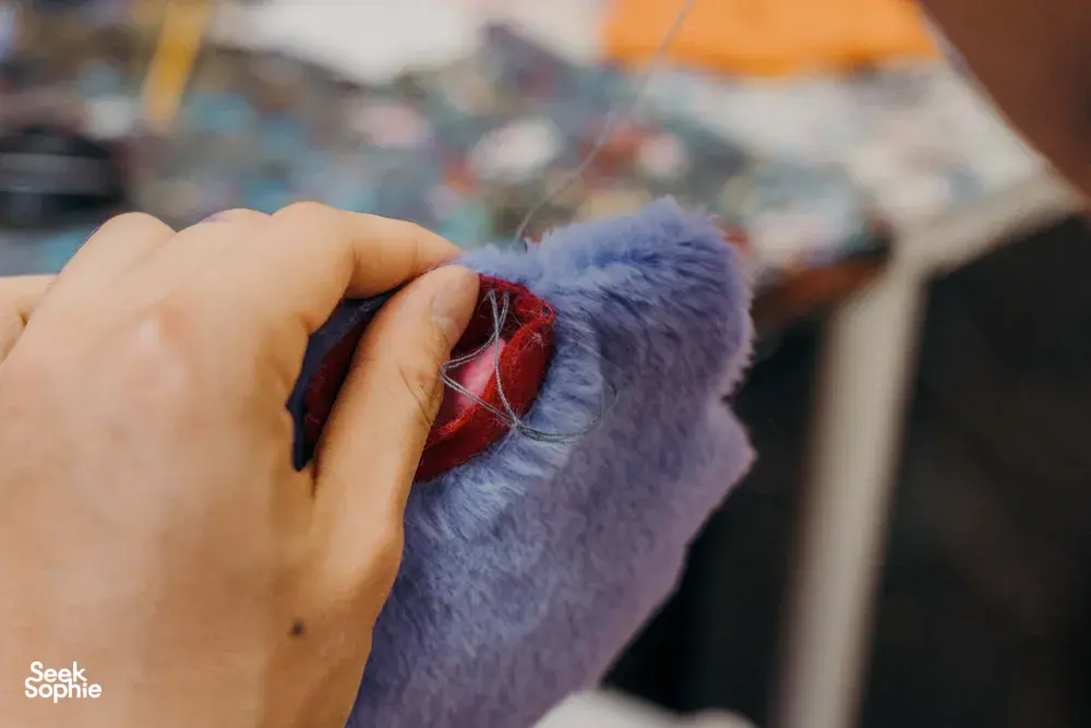 Hands pressing felt pieces together for a plushie keychain at Avant-Garde Art Space in Singapore — workshops in Singapore