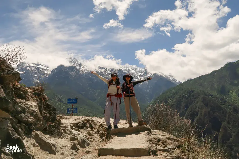 Hikers on stone steps with backpacks in the mountains along Tiger Leaping Gorge, Lijiang, during a 2D1N high-trail trek