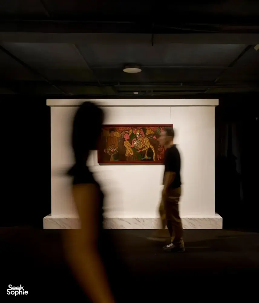 Visitors view framed paintings on an expert-led Vietnamese art tour at Quang San Art Museum in Ho Chi Minh City